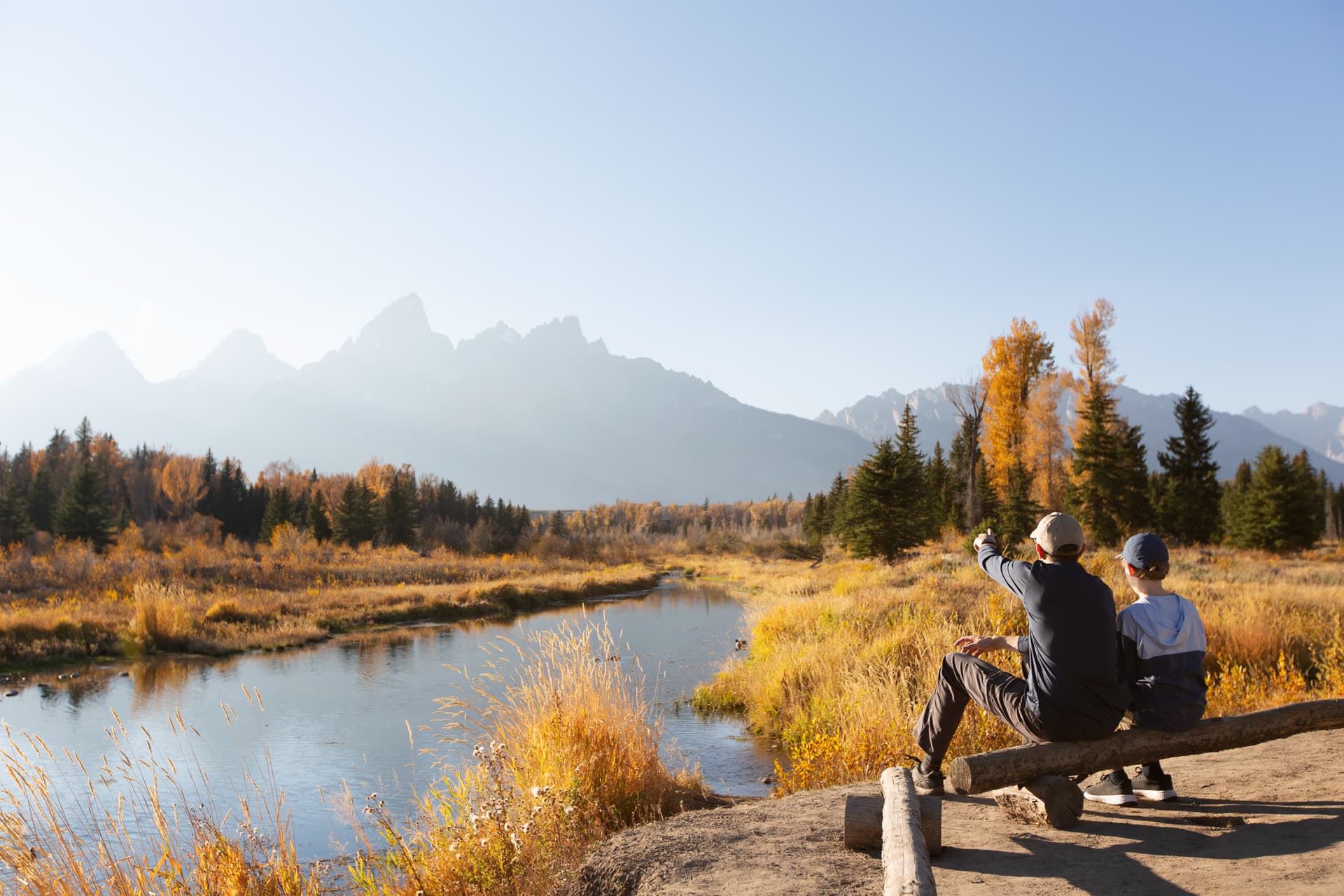 A father and son enjoying a mountain view together